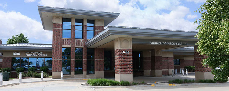 Exterior of DMOS Orthopaedic Outpatient Surgery Center building with main entrance visible.